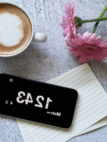 coffee cup black smartphone displaying 12:43 cup